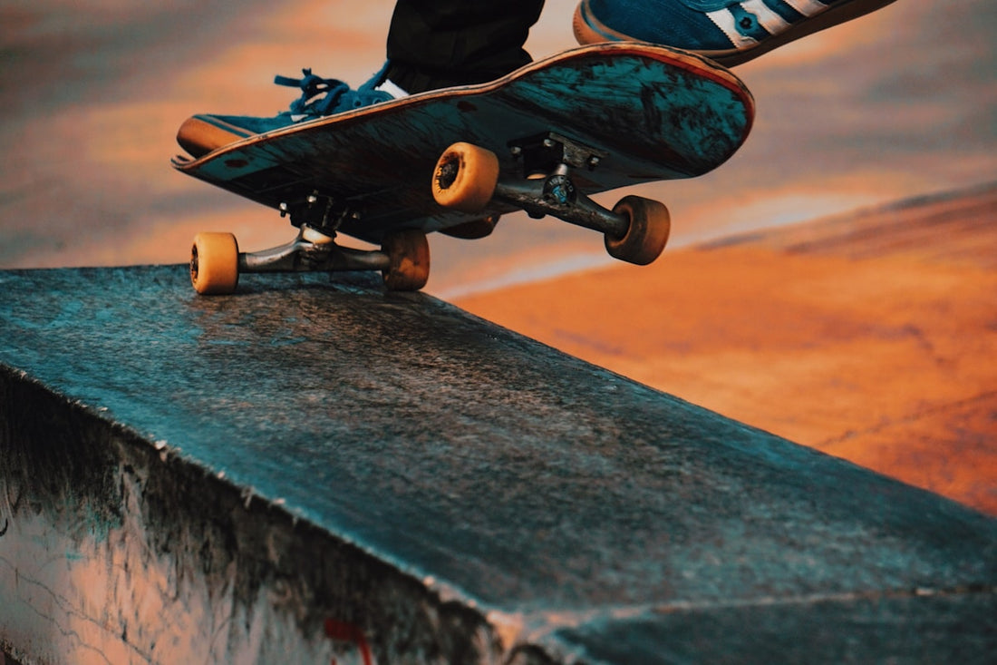Skateboarder performing trick at concrete skate park
